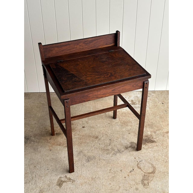 A relic of nineteenth-century American history and early school life, this antique oak children's writing desk features a...