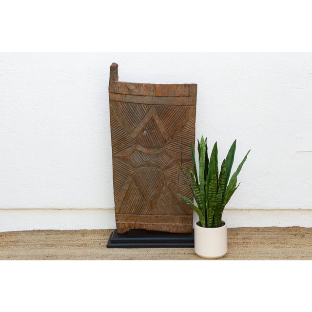 From the Bandiagara escarpment region of Mali, this single-plank granary or shrine door is carved with a bold, radiating...