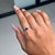 This Solitaire Ring showcases a 0.56 carat natural emerald-cut blue sapphire, set in 14k white gold. The sapphire...