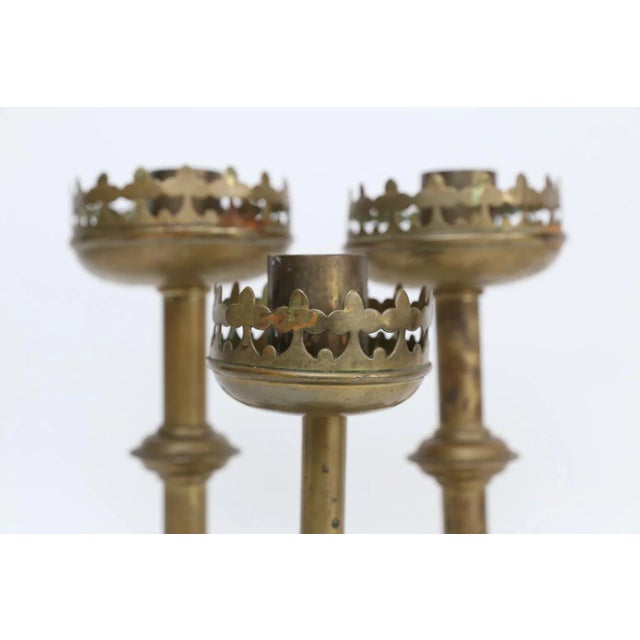 Set of 3 antique brass French altar candlesticks. They have a lovely Gothic Revival-Style decoration. These antique candle...