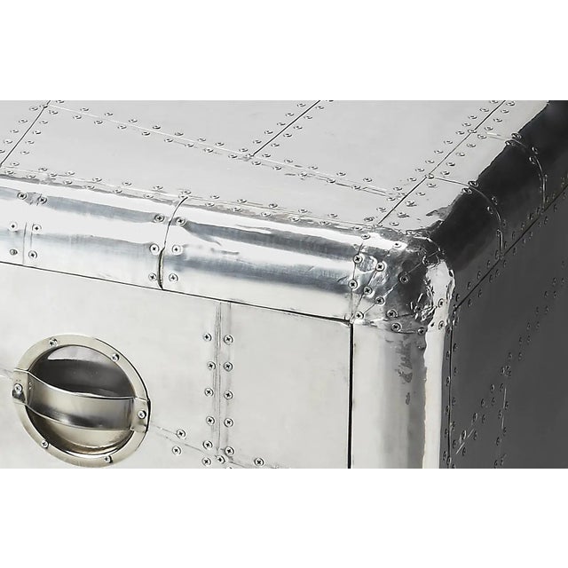 Crafted from polished and riveting aluminum, this bold Chairside Chest provides two drawers for substantial storage. It...