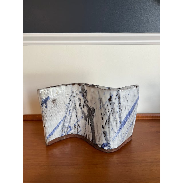 A sculptural contemporary studio pottery Hanukkah menorah featuring an expressive hand-built S-curve form with ten candle...
