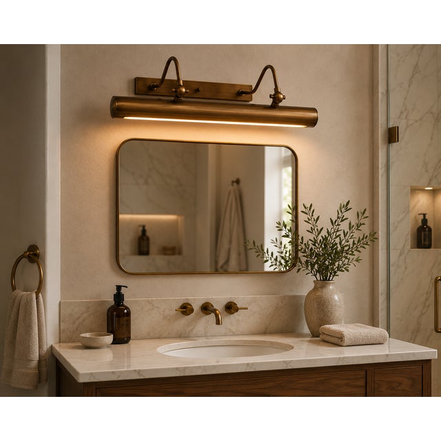 Crafted from solid brass, this handcrafted picture light features a long cylindrical shade supported by two gracefully...