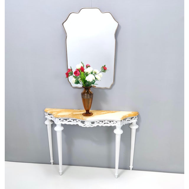 Made in Italy, 1960s. This console features a white lacquered beech frame with a matte finish and a yellow marble top. It...