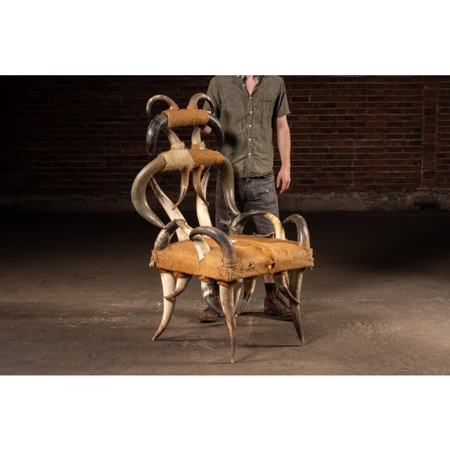 Dramatic handcrafted throne-form chair constructed almost entirely from mounted bovine horns and upholstered hide. The...