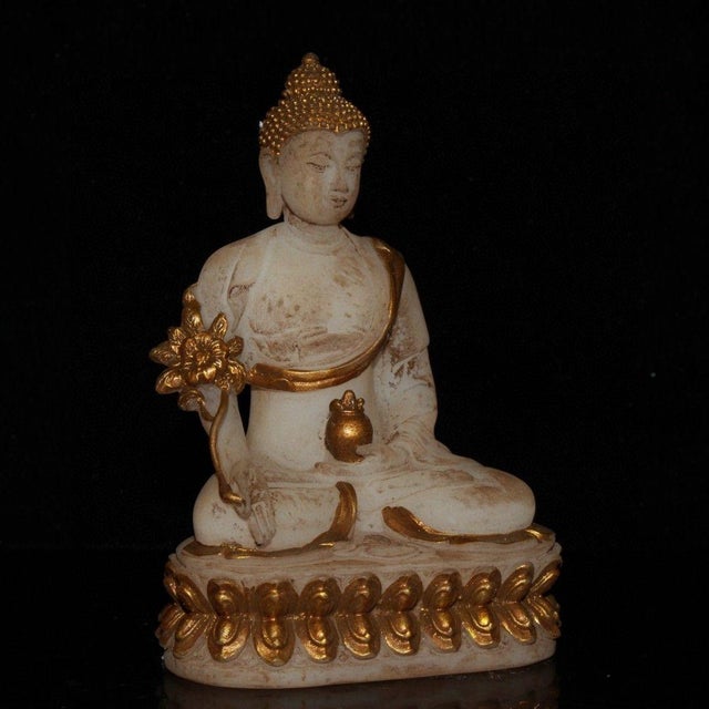 This is a finely crafted antique glass sculpture of Shakyamuni Buddha, the founder of Buddhism. The figure is depicted...