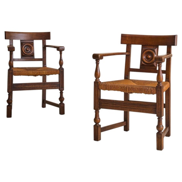A French armchair from the 1940s, in the manner of Charles Dudouyt. The frame is carved in oak, with turned supports at...
