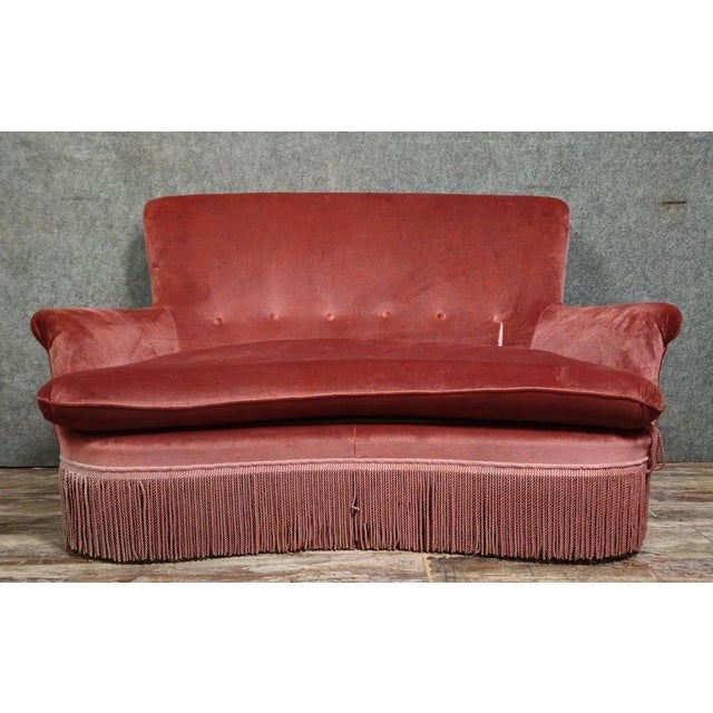 A half-moon shaped toadstool bench, Napoleon III period, upholstered in powder pink velvet. An elegant sofa with rounded...