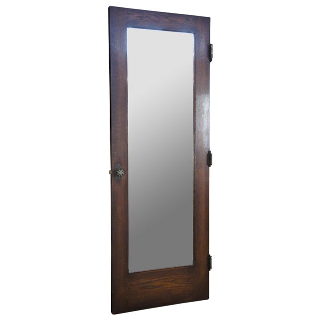 Early 20th century oak door. Features a large crental mirror and Spanish Revival hammered hardware. Reclaimed from one of...