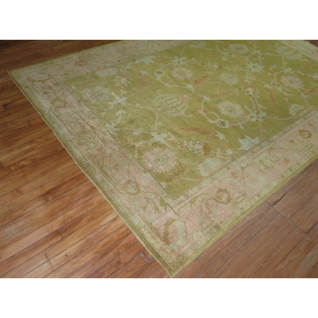 Phenomenal antique Turkish Oushak rug with a warm green field color and pink border. The weave is the best of its kind....