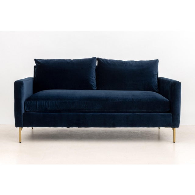 Contemporary Blue Velvet Upholstered Loveseat, on four brass tubular legs. 29" H x 62" W x 37" D; seat: 17.5" H....