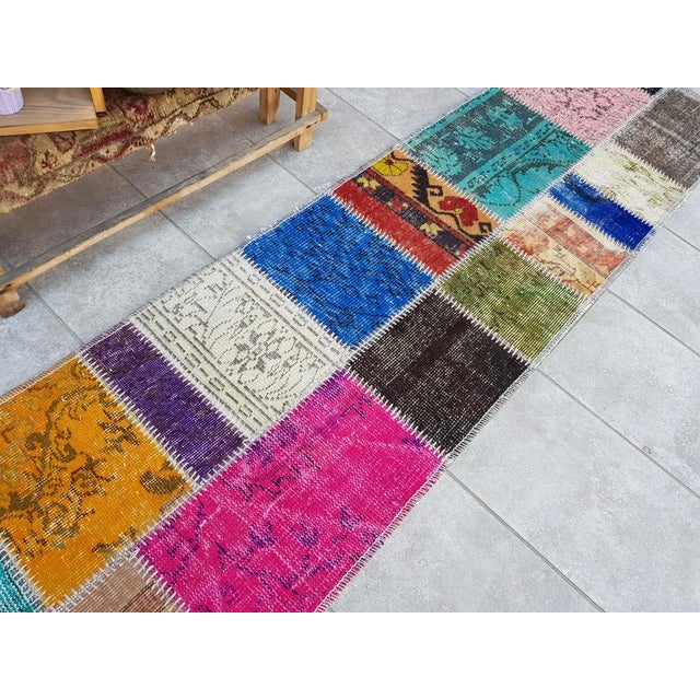 This is a vintage Turkish Oushak rug from the Mid 20th Century. The piece was hand-knotted.