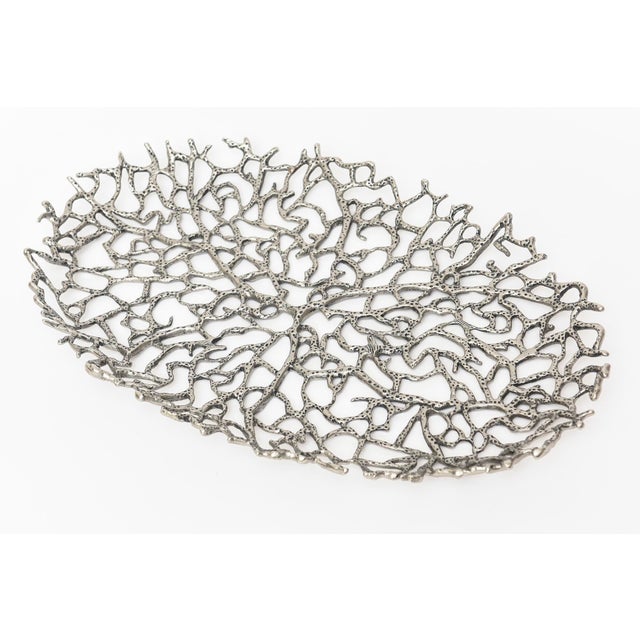 This lovely tray is an open weave design that resembles coral in nickel plated solid brass. It was designed by Donna Karan...