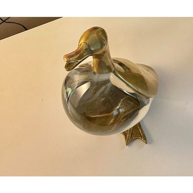 Beautiful decorative Mid Century Modern duck figurine made of solid brass with a clear glass body. Made in Italy. Designed...
