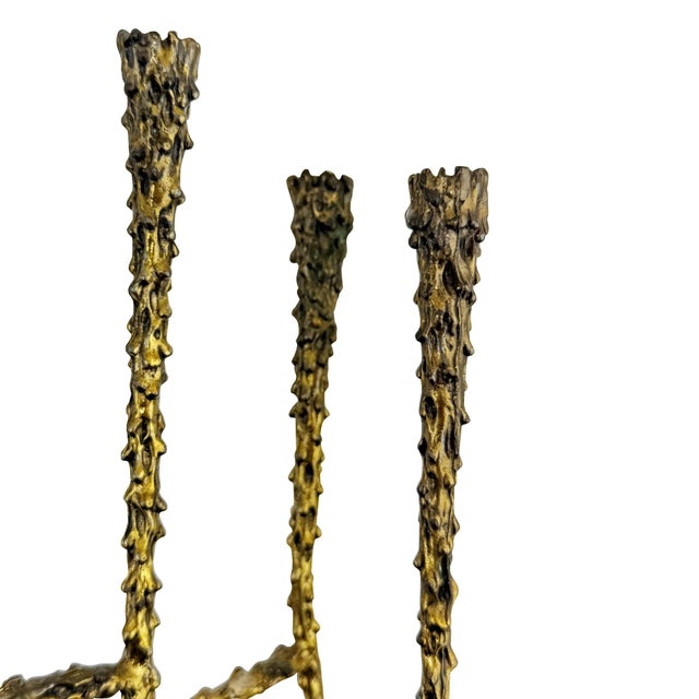 A sculptural Brutalist nine-light candelabra (or Menorah) featuring staggered candle holders, branching horizontal...