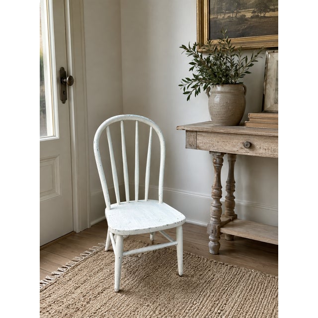 Charming 19th-century American child-sized Windsor side chair featuring a classic hoop-back silhouette with six slender...