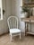 Charming 19th-century American child-sized Windsor side chair featuring a classic hoop-back silhouette with six slender...
