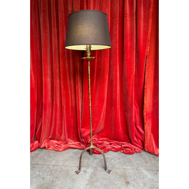 This classic iron floor lamp is a stunning addition to any living space, featuring a hand-patinated gilt finish that adds...