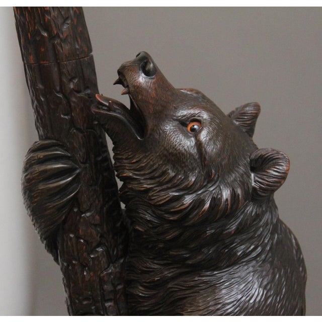 A superb quality and finely carved 19th Century black forest linden wood bear hall stand with a cub playing in the...