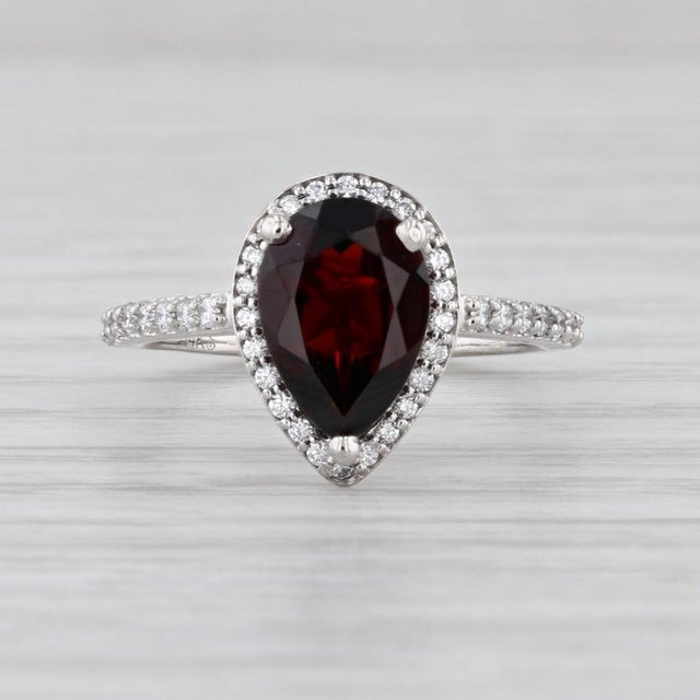 Gemstone Information: - Natural Garnet - Carats - 2.12ct Cut - Pear Color - Dark Red - Natural Diamonds - Total Carats -...