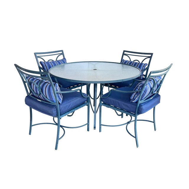 with steel-blue powder-coated finish, the round frosted and textured glass top within a conforming aluminum frame raised...