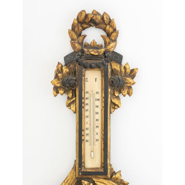 Italian Baroque Style Ebonized and Gilt Composition Barometer, "Made in Italy" label to reverse. 39" H x 6" W x 3" D....