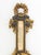 Italian Baroque Style Ebonized and Gilt Composition Barometer, "Made in Italy" label to reverse. 39" H x 6" W x 3" D....