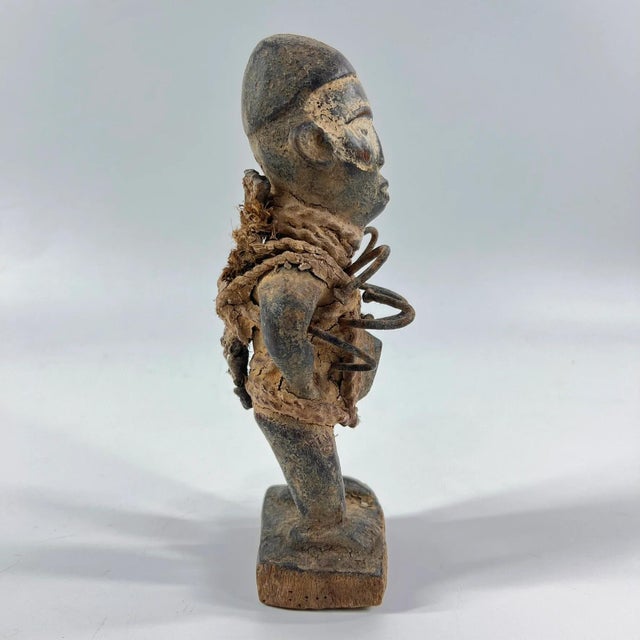The Kongo Nkisi Nkondi Power Fetish Figure from Congo is a striking, handcrafted spiritual object used in rituals to...