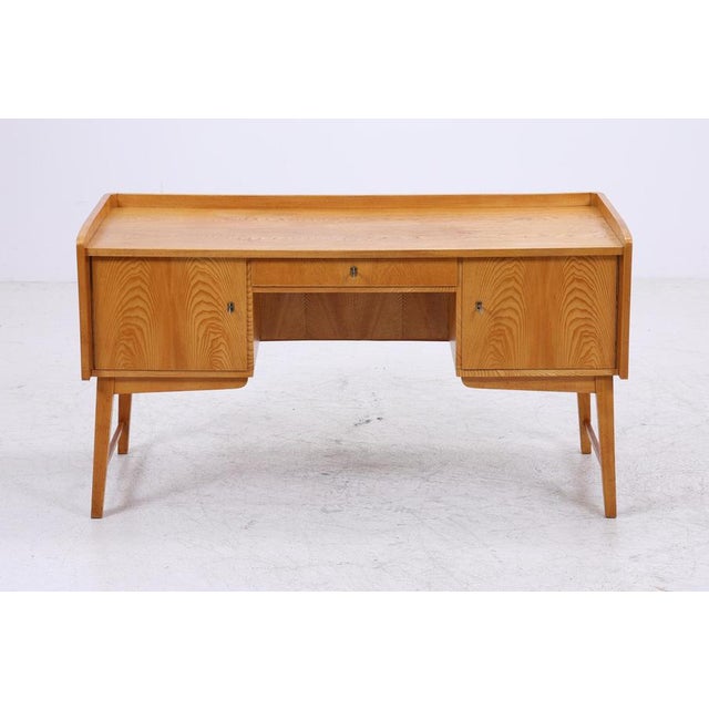 Beautiful vintage ash desk from the 1960s with a clean, freestanding design and a warm, vibrant wood finish. The drawer...