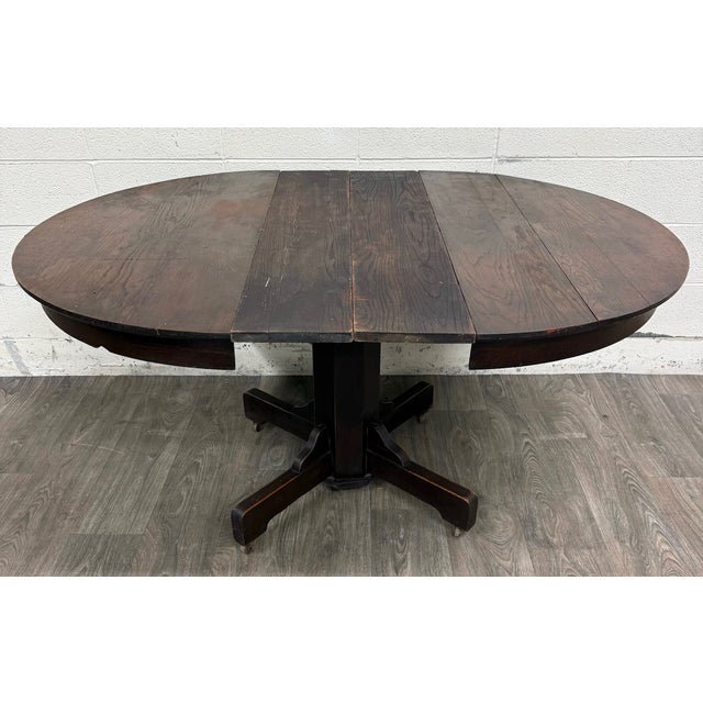 This is a beautiful antique Arts & Crafts Mission quarter-sawn oak pedestal dining table, circa 1905–1925. Features a...