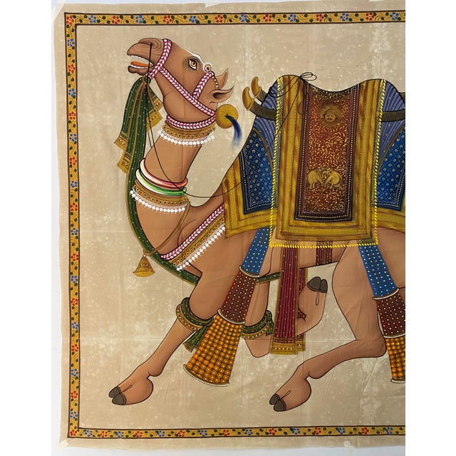 This elegant painting of a beautifully decorated camel in the traditional Rajasthani miniature style. The camel is shown...