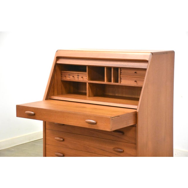A mid century modern teak secretary desk with a slide up top as you open there first drawer made by Dyrlund. Made in...