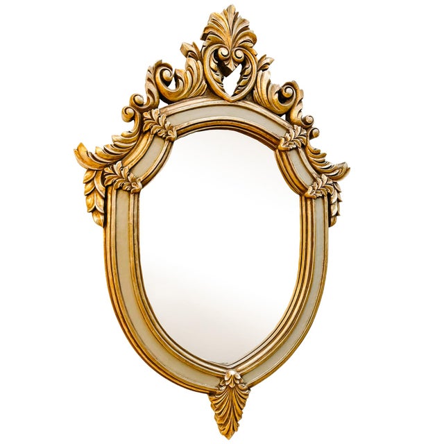 A large mid 20th century Rococo style shield wall mirror featuring with a thick silver-grey inner border and large, deep...