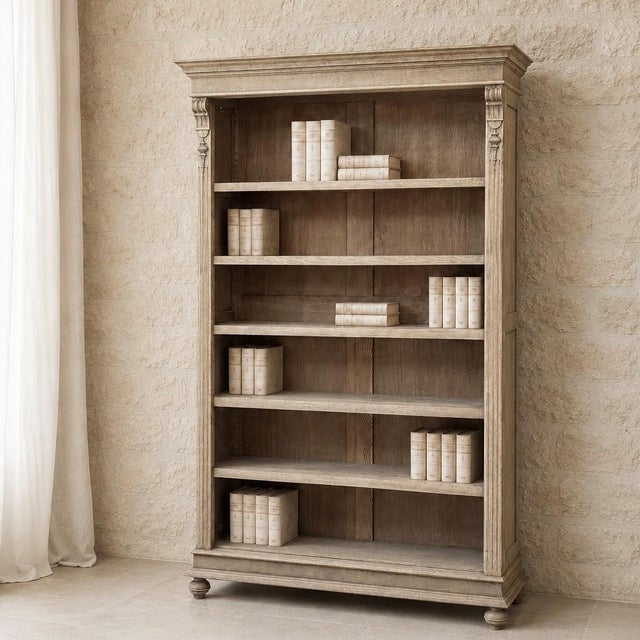 Handsome in form and practical in design, this antique Dutch open bookcase was crafted during the early 1900s from solid...