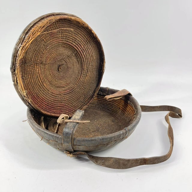 An Ethiopian leather-covered bread basket with a gorgeous patina. Baskets such as this are found among the Oromo and other...