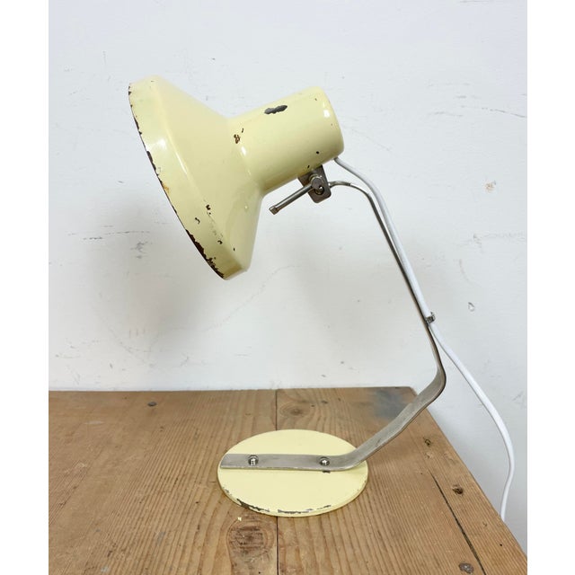 Industrial table lamp made by Metal Mot in Poland during the 1960s. It features a beige base, a beige adjustable shade and...