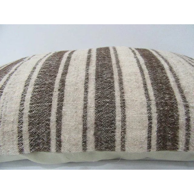 This is a pillow cover made from a vintage kilim rug. The piece was properly washed and ready to use. Pillow inserts not...