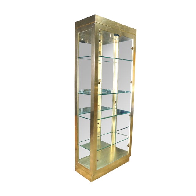 This striking mid-century modern curio display cabinet features a sleek, rectangular column design clad in a brilliant,...