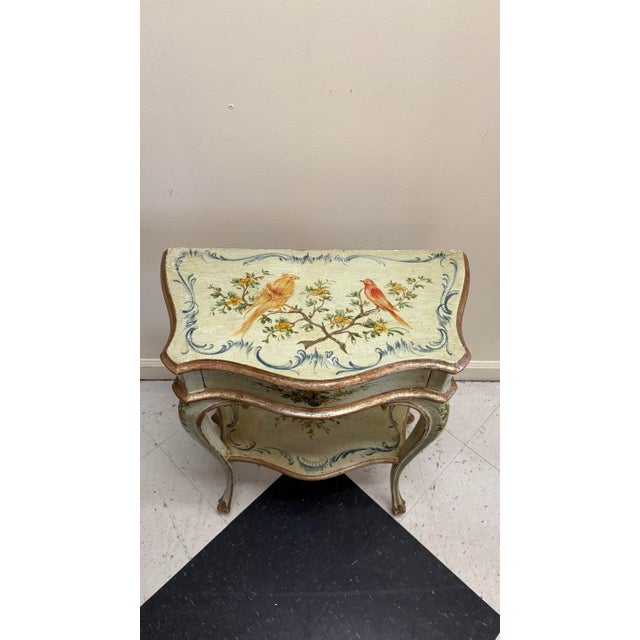 Beautiful early 20th century hand-painted venitian side table with drawer and bottom shelf. The piece is supported by...