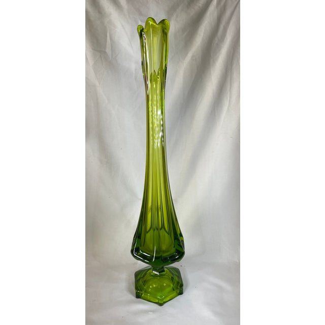 The Mid-Century VIKING Green Pedestal Swung Column Glass Vase is a stunning retro piece that adds a touch of vintage charm...