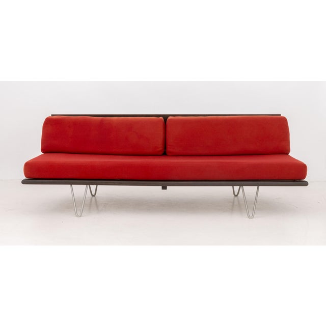 George Nelson for Herman Miller Daybed, walnut frame with red wool upholstered cushions on four steel hairpin legs. 25.75"...