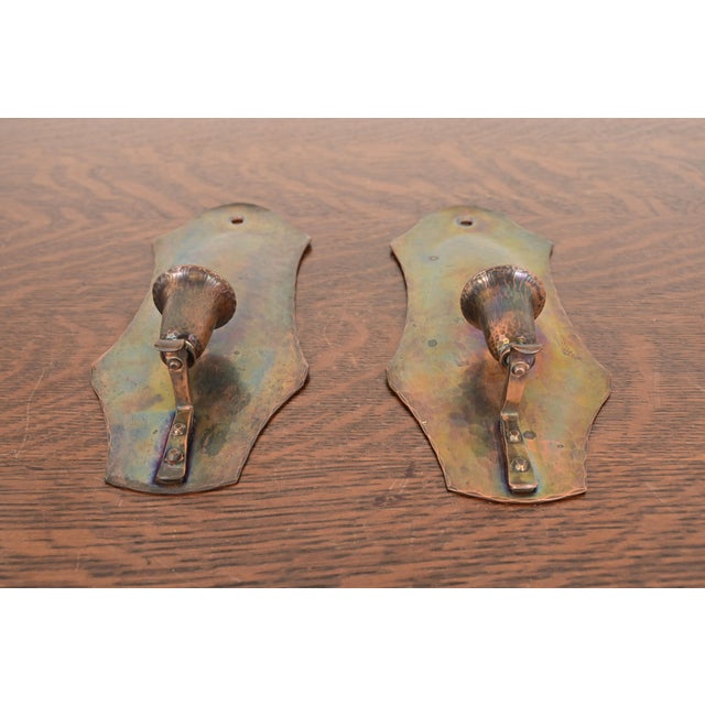 A gorgeous pair of Arts & Crafts period hand hammered copper candle wall sconces By Arthur Cole for The Avon Coppersmith...