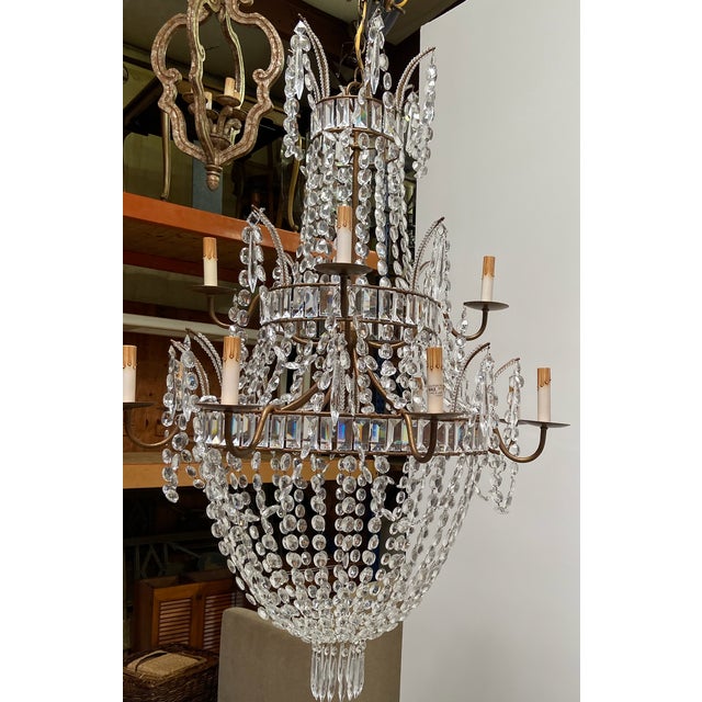Large Empire style crystal chandelier. 12 light with up to 60 watt bulbs each.