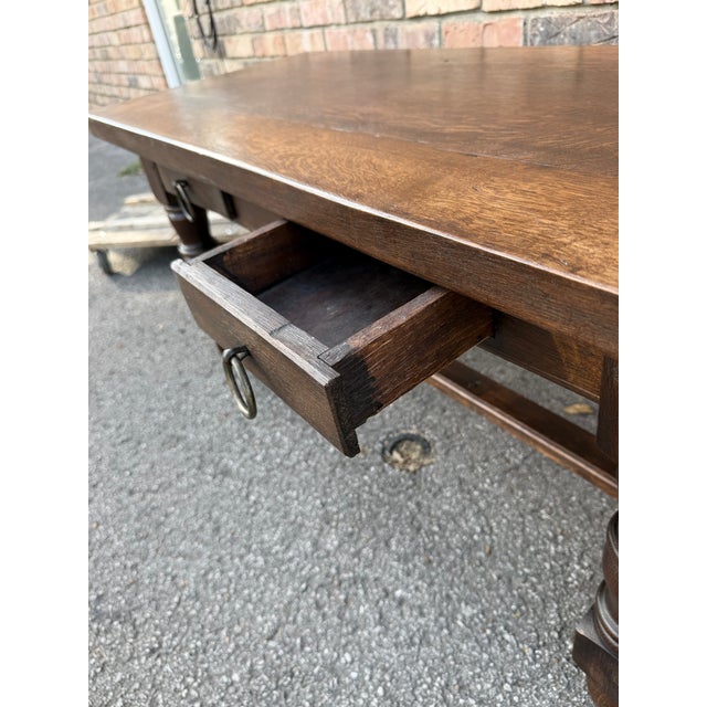 This is antique French dark oak coffee table feature two drawers, both with round iron pulls. The top is thick and solid,...