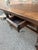 This is antique French dark oak coffee table feature two drawers, both with round iron pulls. The top is thick and solid,...