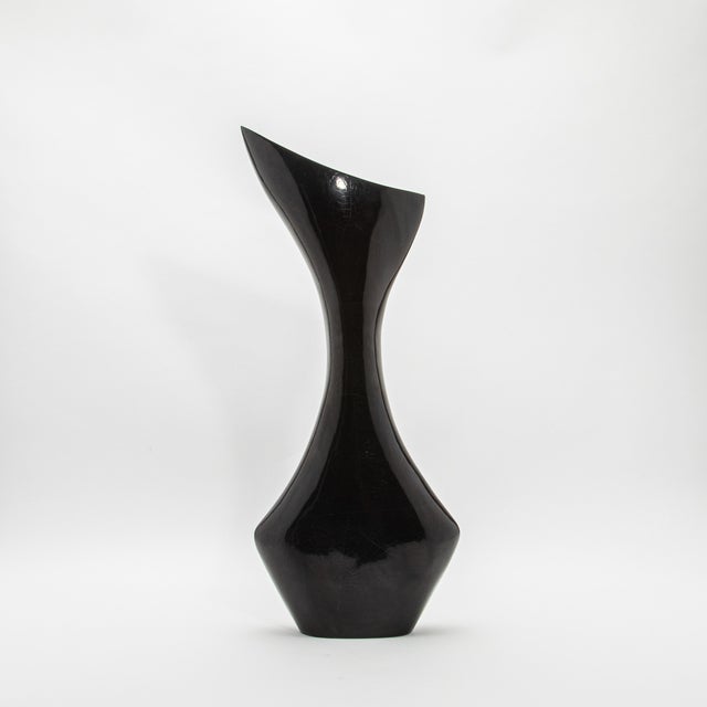 The Bird Vase by R&Y Augousti is a masterful piece that captivates with its sleek, modern silhouette. Handcrafted from...