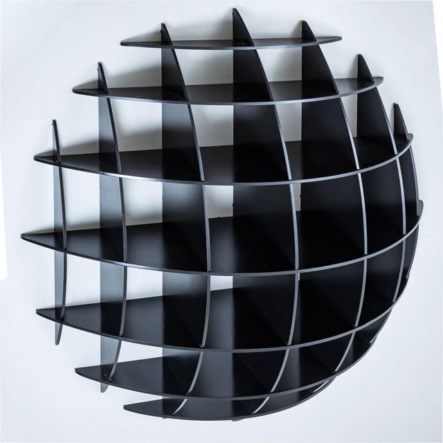 An impressive wall shelf designed by Manfred Massironi for Nikol International. The black shelf features a round base...