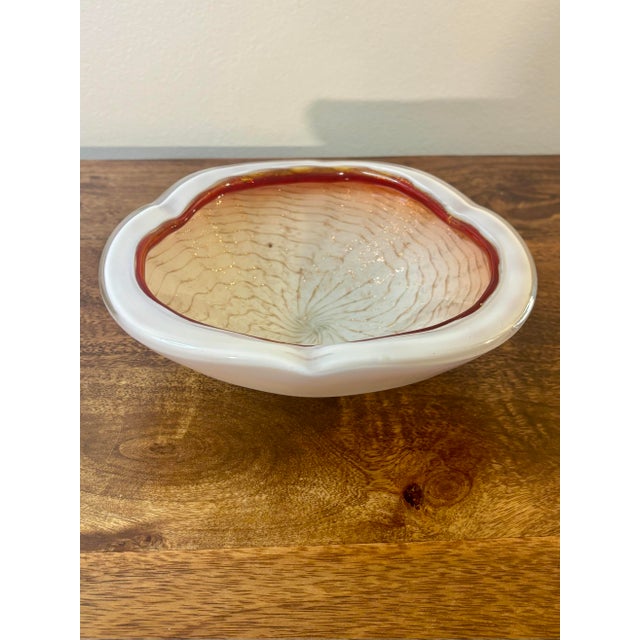 A striking vintage Italian Murano art glass bowl featuring a layered cased white interior suspended beneath thick clear...