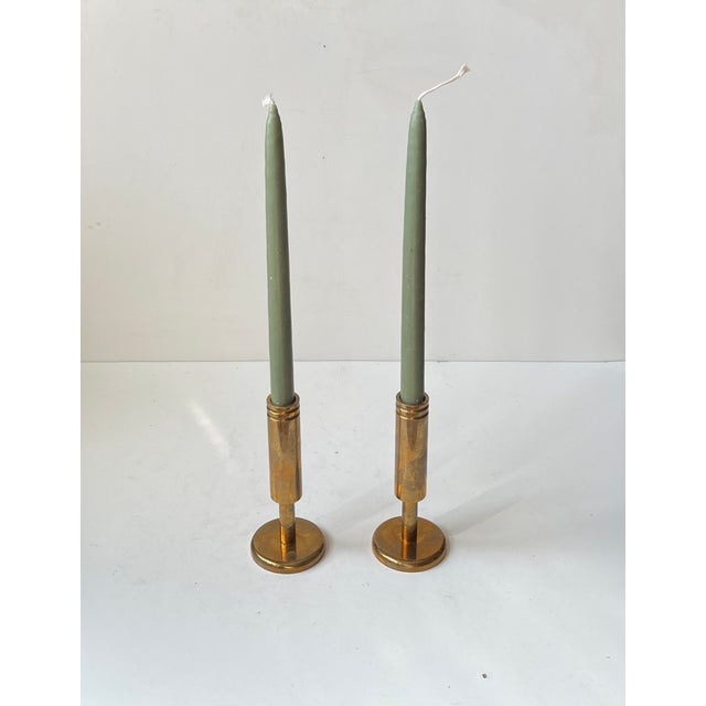 A pair of solid brass candlestick holders designed and manufactured by Dantorp Design in Denmark during the 1960s. Art...