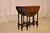 19th century hand carved oak gate leg table from England. This is a lovely side table. The top is made from wonderfully...